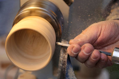 Working on a lathe.